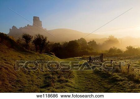 Corfe Castle at dawn on a misty autumnal morning, Dorset, England, UK View Large Photo Image Stock Photograph - Corfe Castle at dawn on a misty autumnal morning, Dorset, England, UK. Fotosearch