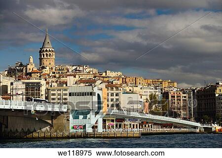 Stock Photography - Galata Tower and Bridge in sun with clouds from Eminonu terminal Istanbul on the Goden Horn. Fotosearch