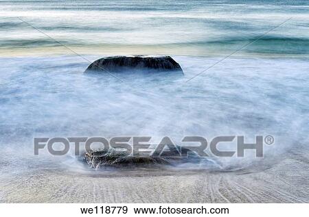 Rock with moving ocean water View Large Photo Image Stock Photo - Rock with moving ocean water. Fotosearch