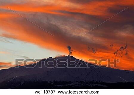 Steam pours from a vent at sunset on the volcano Mount Etna in Sicily, Italy, viewed from Taormina to the North East View Large Photo Image Stock Photo - Steam pours from a vent at sunset on the volcano Mount Etna in Sicily, Italy, viewed from Taormina to the North East. Fotosearch