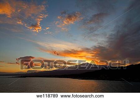 Sunset over the volcano Mount Etna in Sicily, Italy, viewed from Taormina to the North East View Large Photo Image Stock Photo - Sunset over the volcano Mount Etna in Sicily, Italy, viewed from Taormina to the North East. Fotosearch