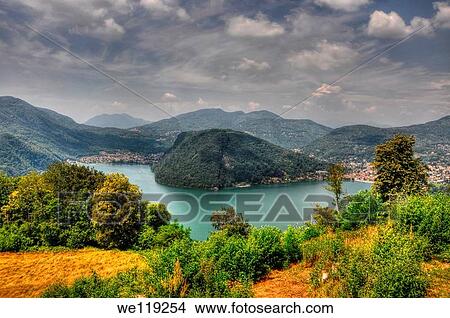 Alpine lake with mountain and trees and gray sky View Large Photo Image Picture - Alpine lake with mountain and trees and gray sky. Fotosearch