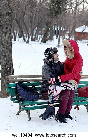 Couple spending a day in a snowy park in Bucharest, Romania View Large Photo Image Picture - Couple spending a day in a snowy park in Bucharest, Romania. Fotosearch