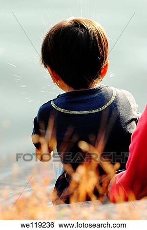 Stock Photograph - Cute little girl posing back side, Poona, Maharashtra, India. Fotosearch