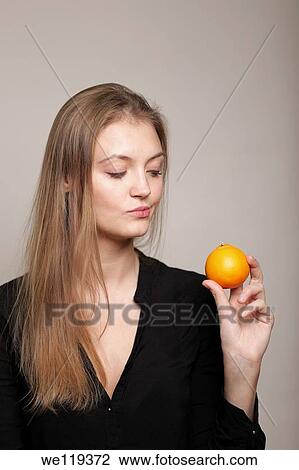 Girl holding orange View Large Photo Image Stock Image - Girl holding orange. Fotosearch