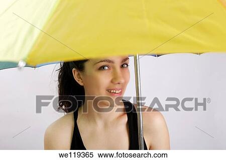 Girl holding yellow umbrella View Large Photo Image Stock Photography - Girl holding yellow umbrella. Fotosearch