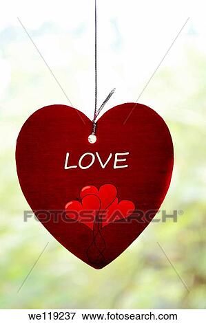 Stock Photo - Hanging red heart, Poona, Maharashtra, India. Fotosearch