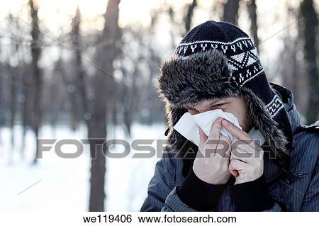 Young man blowing his nose in a snowy park in Bucharest, Romania View Large Photo Image Stock Photograph - Young man blowing his nose in a snowy park in Bucharest, Romania. Fotosearch