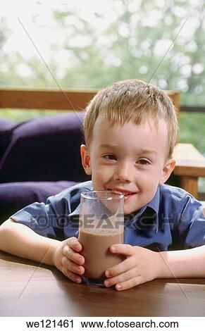 Stock Image - 3-4 year old boy drinking chocolate milk. Fotosearch