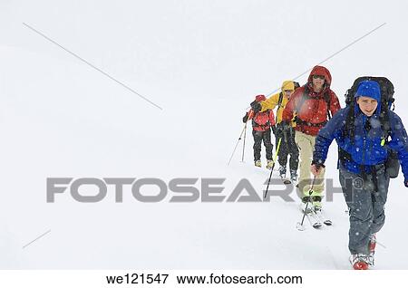 Stock Photo - backcountry skiers climbing slope, Rohr Mountain, Whistler/Pemberton area, BC, Canada. Fotosearch