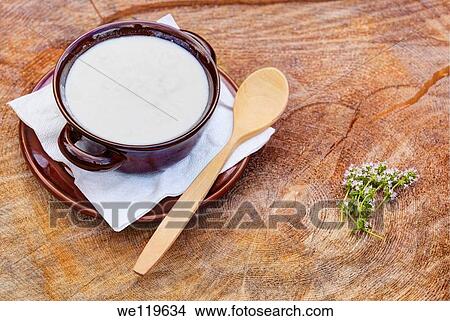 Bowl of organic goat yogurt with wooden spoon View Large Photo Image Picture - Bowl of organic goat yogurt with wooden spoon. Fotosearch