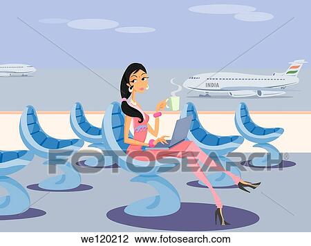 Stock Image - Businesswoman working on a laptop at an airport lounge. Fotosearch