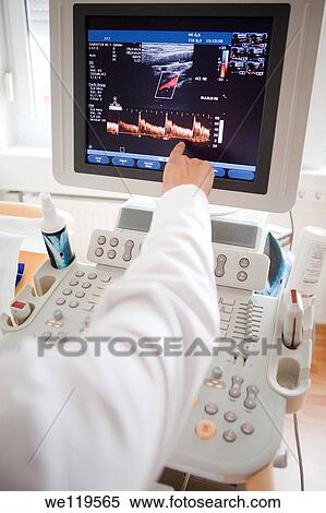 Cardiologist points at monitor showing patients heart rate View Large Photo Image Stock Photography - Cardiologist points at monitor showing patients heart rate. Fotosearch