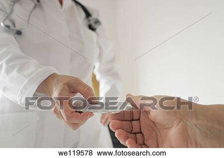 Doctor gives prescription drugs to patient View Large Photo Image Stock Photo - Doctor gives prescription drugs to patient. Fotosearch