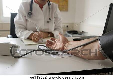 Doctor takes patients blood pressure View Large Photo Image Stock Image - Doctor takes patients blood pressure. Fotosearch