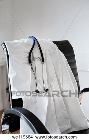 Doctors white coat and stethocope, at the end of the work day View Large Photo Image Picture - Doctors white coat and stethocope, at the end of the work day. Fotosearch