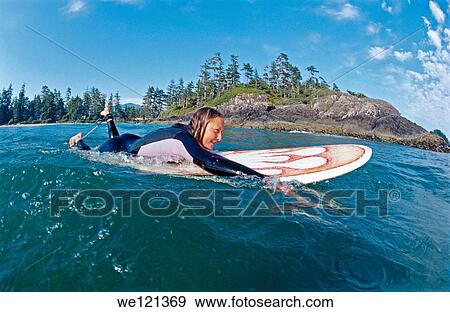Stock Photo - Female surfer, aged 25-30 Tofino British Columbia Canada. Fotosearch