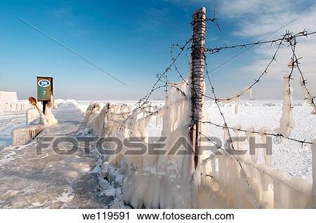 Stock Image - Icy barbed wire, frozen Black Sea, a rare phenomenon, occured in 1977 for the last time, Odessa, Ukraine, Eastern Europe. Fotosearch