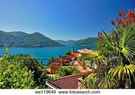 Panoramic view over an alpine lake with houses and mountain View Large Photo Image Stock Photo - Panoramic view over an alpine lake with houses and mountain. Fotosearch
