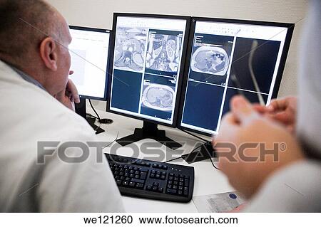 Radiologist having a discussion, reading MRI scans on monitor View Large Photo Image Stock Image - Radiologist having a discussion, reading MRI scans on monitor. Fotosearch