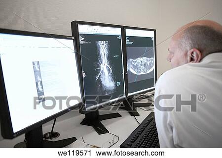 Stock Image - Radiologist reading MRI scan. Fotosearch