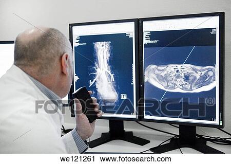 Radiologist reading MRI scan View Large Photo Image Stock Image - Radiologist reading MRI scan. Fotosearch