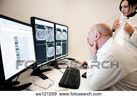 Stock Photo - Radiologist reading MRI scans. Fotosearch