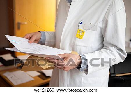 Radiologist wearing a radiation dosimeter badge View Large Photo Image Stock Photo - Radiologist wearing a radiation dosimeter badge. Fotosearch