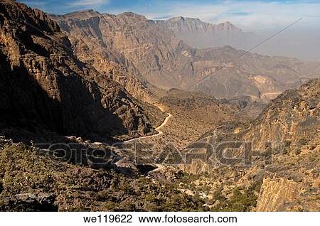 Rough road from the pass Sharaf al Alamayn through the wild mountainous landscape of the Al Hajar mountains to the oasis Haat, Sultanate of Oman View Large Photo Image Stock Image - Rough road from the pass Sharaf al Alamayn through the wild mountainous landscape of the Al Hajar mountains to the oasis Haat, Sultanate of Oman. Fotosearch