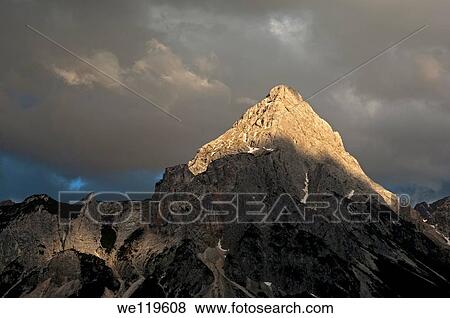 The peak Ehrwalder Sonnenspitze in the eerie light of an approaching thunderstorm, Mieminger mountain range, Ehrwald, Tyrol, Austria View Large Photo Image Stock Photo - The peak Ehrwalder Sonnenspitze in the eerie light of an approaching thunderstorm, Mieminger mountain range, Ehrwald, Tyrol, Austria. Fotosearch