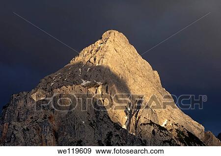 The peak Ehrwalder Sonnenspitze in the eerie light of an approaching thunderstorm, Mieminger mountain range, Ehrwald, Tyrol, Austria View Large Photo Image Stock Photo - The peak Ehrwalder Sonnenspitze in the eerie light of an approaching thunderstorm, Mieminger mountain range, Ehrwald, Tyrol, Austria. Fotosearch