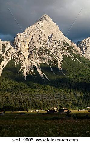 The peak Ehrwalder Sonnenspitze in the eerie light of an approaching thunderstorm, Mieminger mountain range, Ehrwald, Tyrol, Austria View Large Photo Image Stock Photograph - The peak Ehrwalder Sonnenspitze in the eerie light of an approaching thunderstorm, Mieminger mountain range, Ehrwald, Tyrol, Austria. Fotosearch
