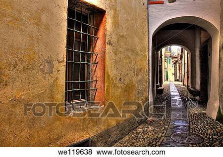 Tight alley with old rustic houses View Large Photo Image Stock Photo - Tight alley with old rustic houses. Fotosearch