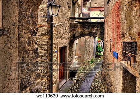 Tight alley with old rustic houses View Large Photo Image Stock Photo - Tight alley with old rustic houses. Fotosearch