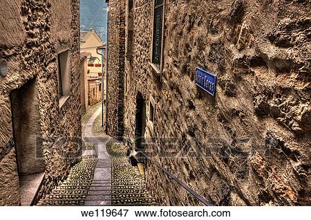 Tight alley with old rustic houses View Large Photo Image Stock Photo - Tight alley with old rustic houses. Fotosearch