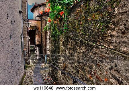 Tight alley with old rustic houses View Large Photo Image Stock Photo - Tight alley with old rustic houses. Fotosearch