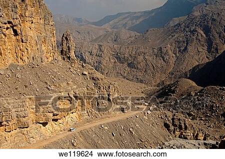 White off-road vehicle on a rough road amidst the rugged mountains on the way to Mount Jebel Harim, Musandam peninsula, Sultanate of Oman View Large Photo Image Picture - White off-road vehicle on a rough road amidst the rugged mountains on the way to Mount Jebel Harim, Musandam peninsula, Sultanate of Oman. Fotosearch