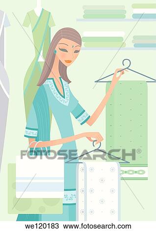 Woman choosing sarees in a clothing store View Large Photo Image Stock Image - Woman choosing sarees in a clothing store. Fotosearch