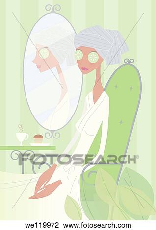 Stock Image - Woman with cucumber slices on her eyes. Fotosearch
