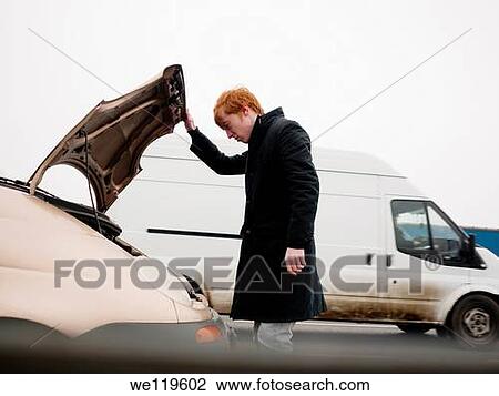 Young man having car problems on a highway in Romania View Large Photo Image Stock Image - Young man having car problems on a highway in Romania. Fotosearch