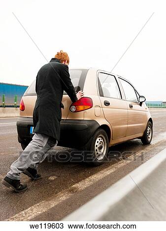 Young man having car problems on a highway in Romania View Large Photo Image Stock Image - Young man having car problems on a highway in Romania. Fotosearch