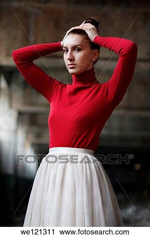 Stock Image - Young woman in abandoned ruins in Bucharest, Romania. Fotosearch