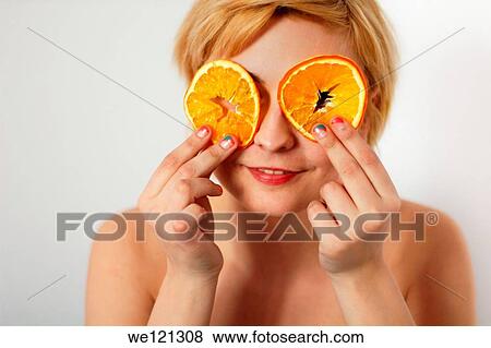 Young woman posing with orange slices in Bucharest, Romania View Large Photo Image Stock Photo - Young woman posing with orange slices in Bucharest, Romania. Fotosearch