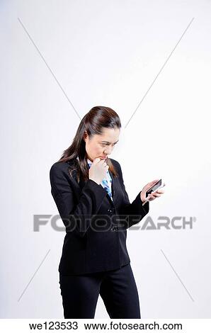 A mixed race woman looking at the telephone She is wearing a black suit, she has long brown hair She has her hand under her chin View Large Photo Image Stock Image - A mixed race woman looking at the telephone She is wearing a black suit, she has long brown hair She has her hand under her chin. Fotosearch