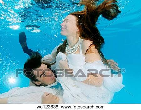 Stock Photography - Bridal couple, underwater wedding in pool. Fotosearch