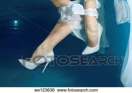 Stock Photograph - Bride´s feet, underwater wedding in pool. Fotosearch