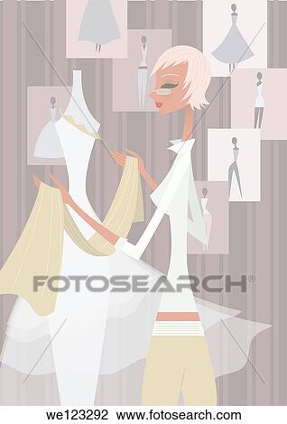 Stock Image - Female fashion designer in a boutique. Fotosearch