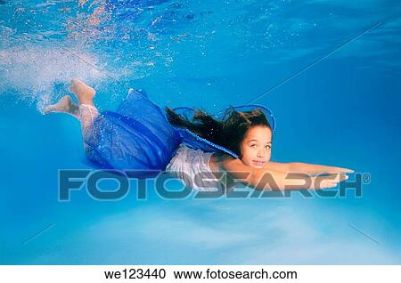 Girl presenting underwater fashion in pool View Large Photo Image Stock Image - Girl presenting underwater fashion in pool. Fotosearch