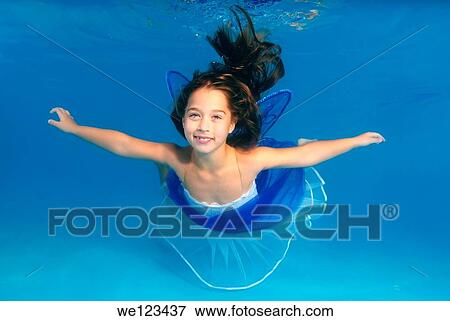 Girl presenting underwater fashion in pool View Large Photo Image Stock Photo - Girl presenting underwater fashion in pool. Fotosearch
