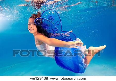 Girl presenting underwater fashion in pool View Large Photo Image Stock Photo - Girl presenting underwater fashion in pool. Fotosearch